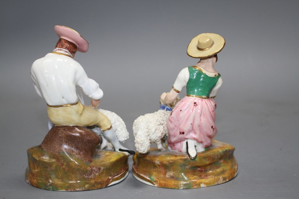 A pair of Staffordshire porcelain groups of a shepherd and shepherdess, c.1830-50, H. 11.5 -12.5cm